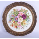 A superb early 19th c. English porcelain plaque lavishly painted with flowers in a circular gilded f