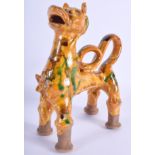 A MIDDLE EASTERN TURKISH POTTERY CANAKKALE LION FIGURE with green and yellow glaze. 16 cm x 20 cm.