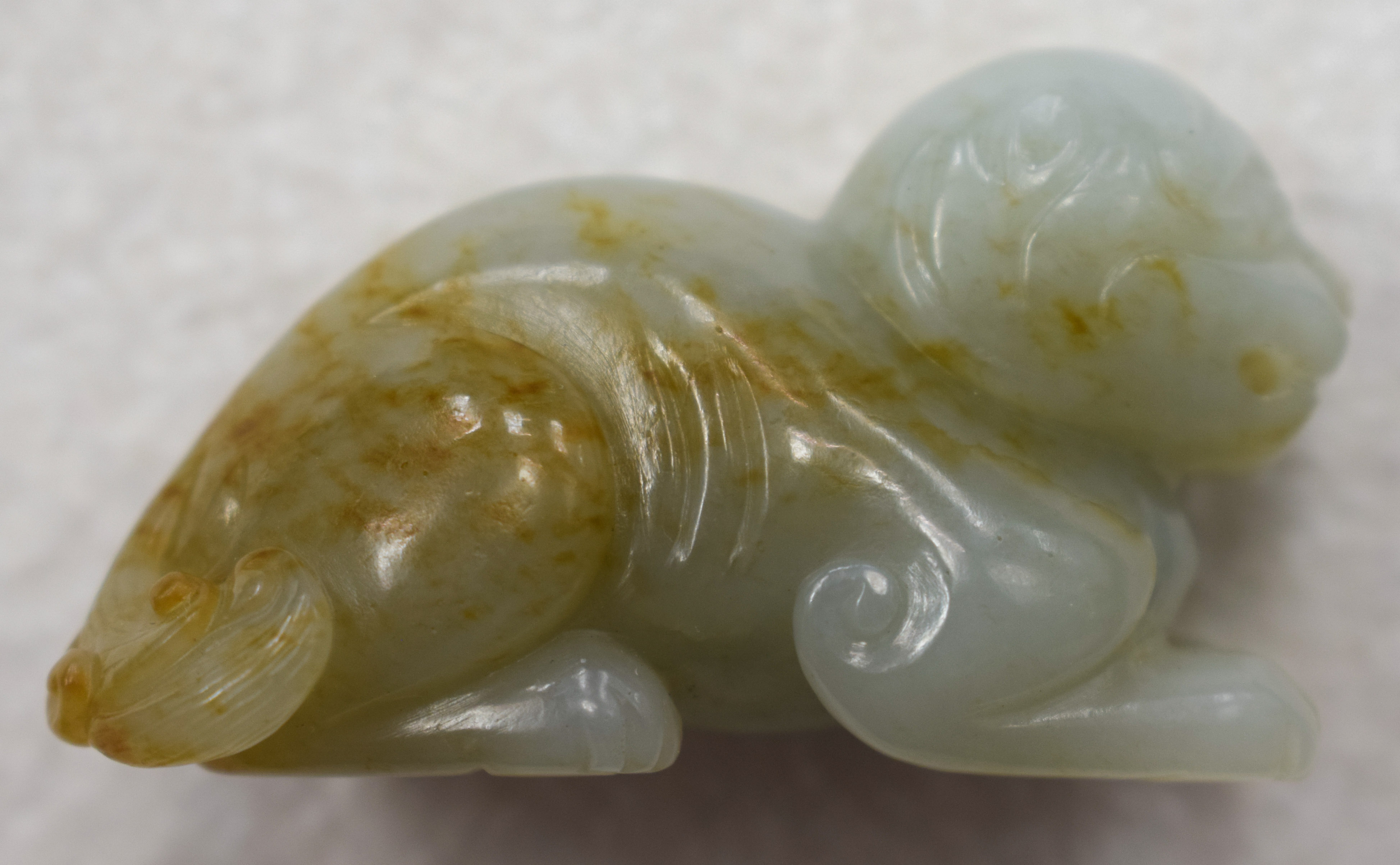 A 19TH CENTURY CHINESE CARVED GREENISH WHITE JADE BEAST Qing, with russet inclusions. 5.5 cm wide. - Image 5 of 9