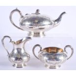 A VICTORIAN STYLE THREE PIECE SILVER TEASET. Sheffield 1958. 1070 grams. Largest 25 cm wide. (3)