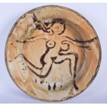 Manner of Eric James Mellon (1925-2014) A large studio pottery dish, decorated with a figurative dra
