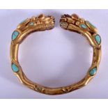 A CHINESE TIBETAN BRONZE TURQUOISE AND CORAL BANGLE. 8 cm wide.