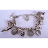 A VINTAGE SILVER CHARM BRACELET. 60.8 grams.