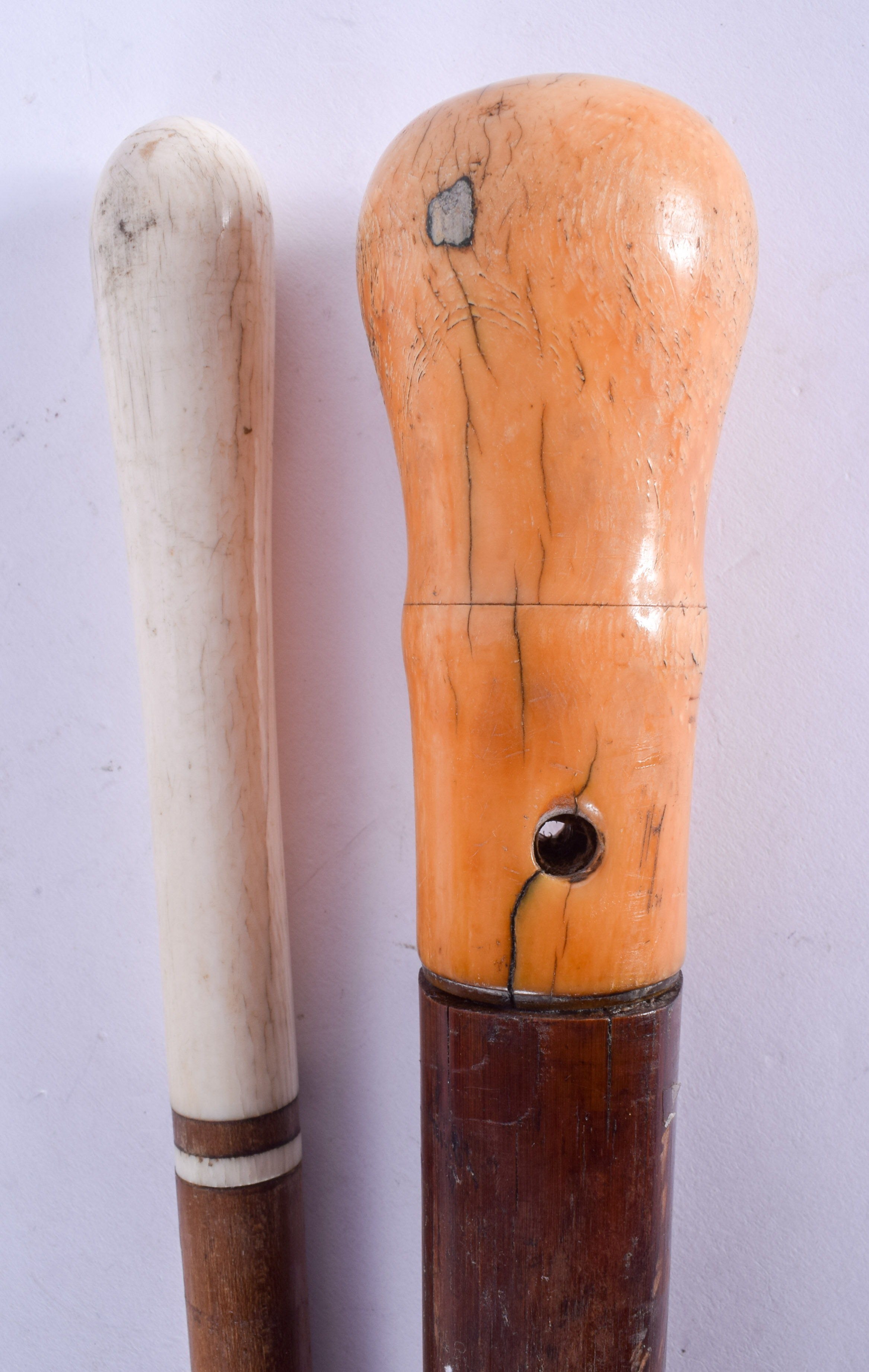 A LATE 18TH CENTURY IVORY HANDLED CANE together with another. 84 cm long. (2)