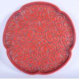 A CHINESE QING DYNASTY RED TIXI SCALLOPED LACQUER DISH carved with motifs. 33 cm wide. Note: See a v