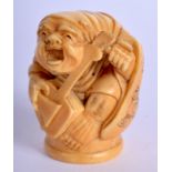 A 19TH CENTURY JAPANESE MEIJI PERIOD CARVED IVORY FIGURE OF A MUSICIAN possibly a cane handle. 4 cm