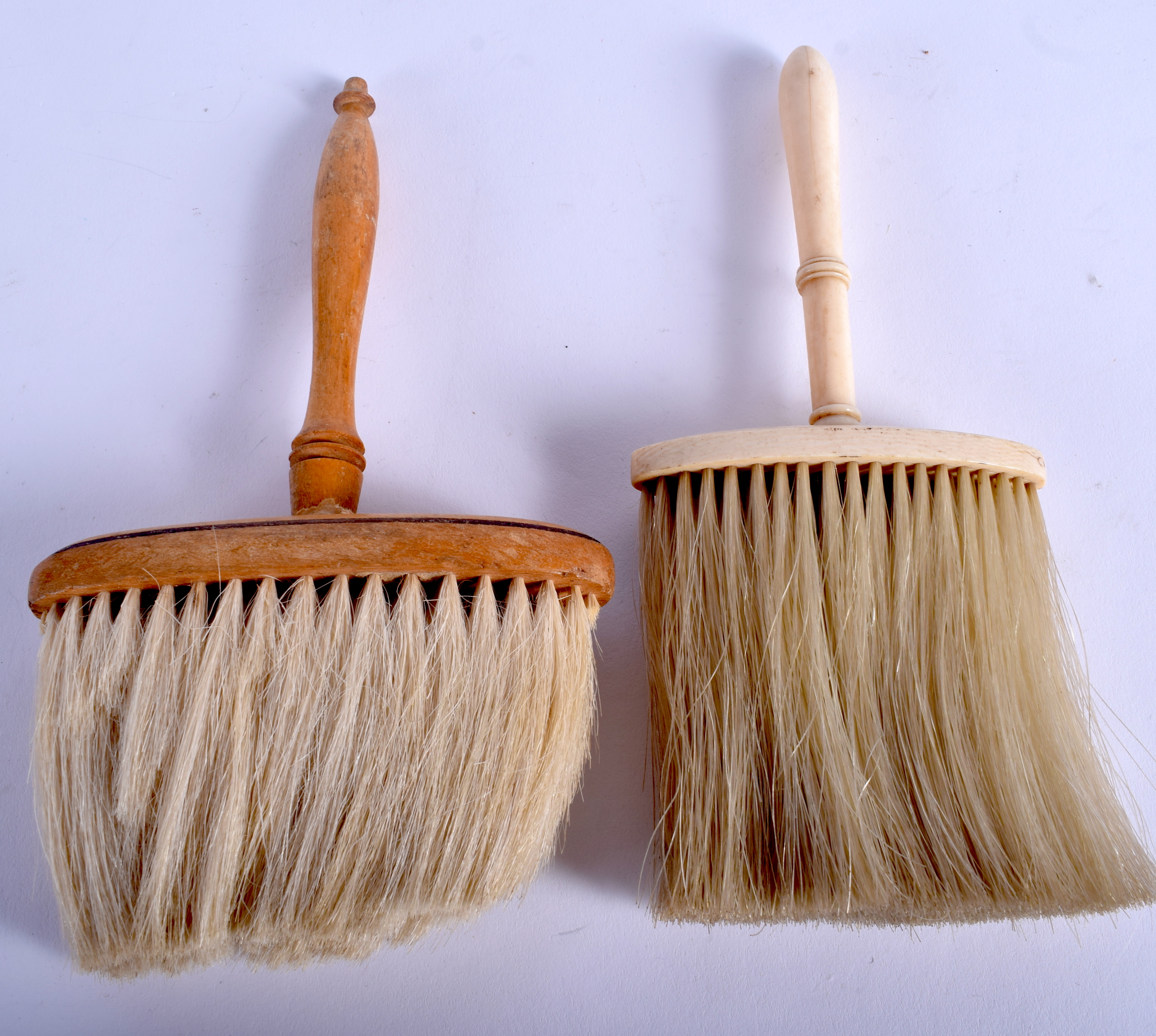 AN ANTIQUE IVORY BRUSH and another. (2)