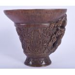 A CHINESE CARVED BUFFALO HORN LIBATION CUP decorated with archaic motifs. 12 cm x 14 cm.