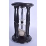 AN ANTIQUE EBONISED SAND TIMER. 24 cm high.