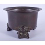 A 19TH CENTURY CHINESE CIRCULAR BRONZE CENSER modelled with three seated figures. 11.5 cm x 7 cm.
