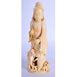A 19TH CENTURY CHINESE CARVED IVORY FIGURE OF AN IMMORTAL modelled holding chained hounds. 15 cm hig