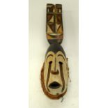 A TRIBAL IGBO MASK. Nigeria. 10cm x 14cm x 49cm