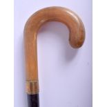 A 19TH CENTURY CONTINENTAL CARVED RHINOCEROS HORN HANDLED WALKING CANE. 88 cm long.