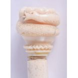 AN 18TH/19TH CENTURY CONTINENTAL CARVED IVORY SAILORS FIST CANE with whalebone shaft. 86 cm long.
