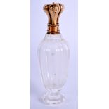 AN ANTIQUE GOLD AND CRYSTAL GLASS SCENT BOTTLE. 9 cm high.