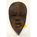 A TRIBAL DAN MASK. Ivory Coast. 15cm x 8cm x 26cm