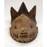 A TRIBAL YORUBA MASK. Nigeria. 17cm x 19cm x 28cm