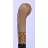 A 19TH CENTURY CONTINENTAL CARVED RHINOCEROS HORN HANDLED WALKING CANE. 88 cm long.