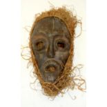 A TRIBAL AFRICAN MASK. 17cm x 6cm x 30cm