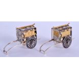 A RARE PAIR OF JAPANESE MEIJI PERIOD SILVER MIXED METAL CONDIMENTS formed as rickshaws. 52 grams. 5.