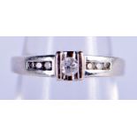 A GOLD AND 0.2 CT DIAMOND RING. L. 2.5 grams.