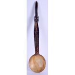 A TRIBAL AFRICAN CARVED BUFFLAO HORN SPOON. 27 cm long.