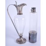 AN ART NOUVEAU SILVER AND GLASS CLARET JUG together with a bottle. 28 cm & 24 cm high. (2)