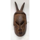 A TRIBAL GURO MASK. Ivory Coast. 16cm x 10cm x 48cm