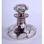 AN ART NOUVEAU SILVER OVERLAID SCENT BOTTLE. 8 cm high.