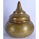 A 19TH CENTURY MIDDLE EASTERN ISLAMIC BRASS JAR AND COVER decorated with kufic script. 25 cm x 18 cm