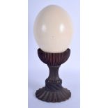 AN ANTIQUE TURNED HARDWOOD SCROLLING STAND with associated ostrich egg. 34 cm x 11 cm.