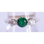 A VINTAGE 9CT GOLD EMERALD AND DIAMOND RING. O. 2.5 grams.