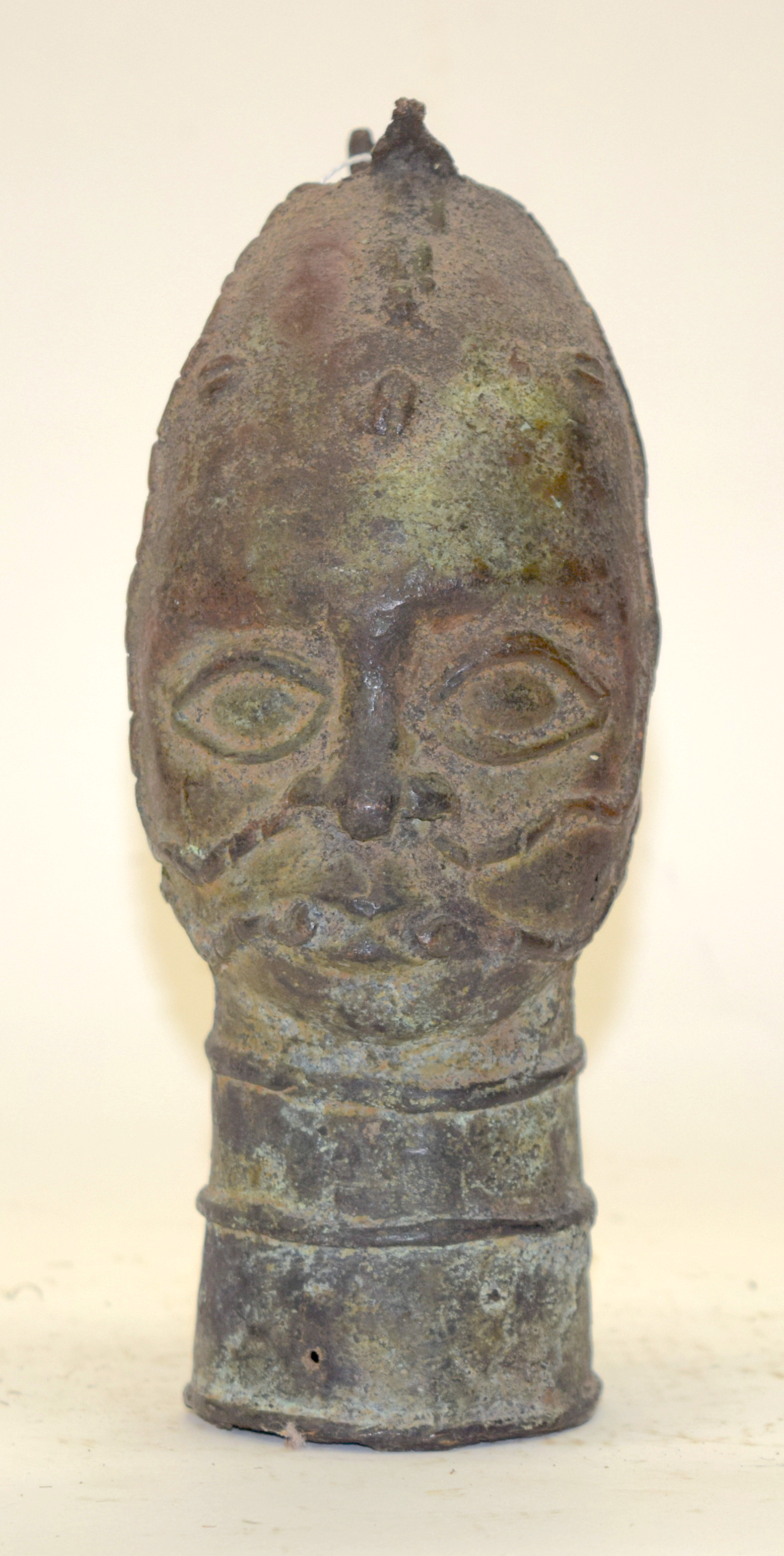 A TRIBAL BRONZE (POSSIBLY BENIN) HEAD. Nigeria. 9cm x 10cm x 24cm