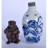 A JAPANESE BRONZE MONKEY together with a blue and white snuff bottle. (2)