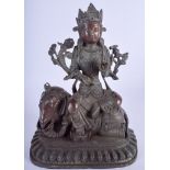 A CHINESE BRONZE FIGURE OF GUANYIN modelled riding upon an elephant. 26 cm x 16 cm.