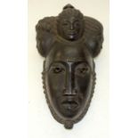 A TRIBAL BAULE FOUR HEADED MASK. Ivory Coast. 19cm x 16cm x 34cm