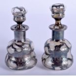 A PAIR OF ART NOUVEAU SILVER OVERLAID SCENT BOTTLES. 8 cm high.