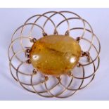 A VINTAGE YELLOW METAL AND AMBER BROOCH. 4 cm wide.