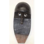 A TRIBAL DAN MASK. Ivory Coast. 13cm x 10cm x 31cm