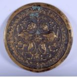 A MIDDLE EASTERN ISLAMIC BRASS SALJUK BRASS MIRROR decorated with beasts. 11 cm wide.