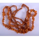 TWO CRUSHED AMBER NECKLACES. 64 cm long. (2)