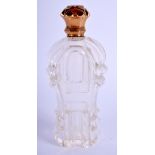 AN ANTIQUE GOLD AND CRYSTAL GLASS SCENT BOTTLE. 11 cm high.