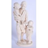 A 19TH CENTURY JAPANESE MEIJI PERIOD CARVED IVORY OKIMONO modelled as a father and two children. 19