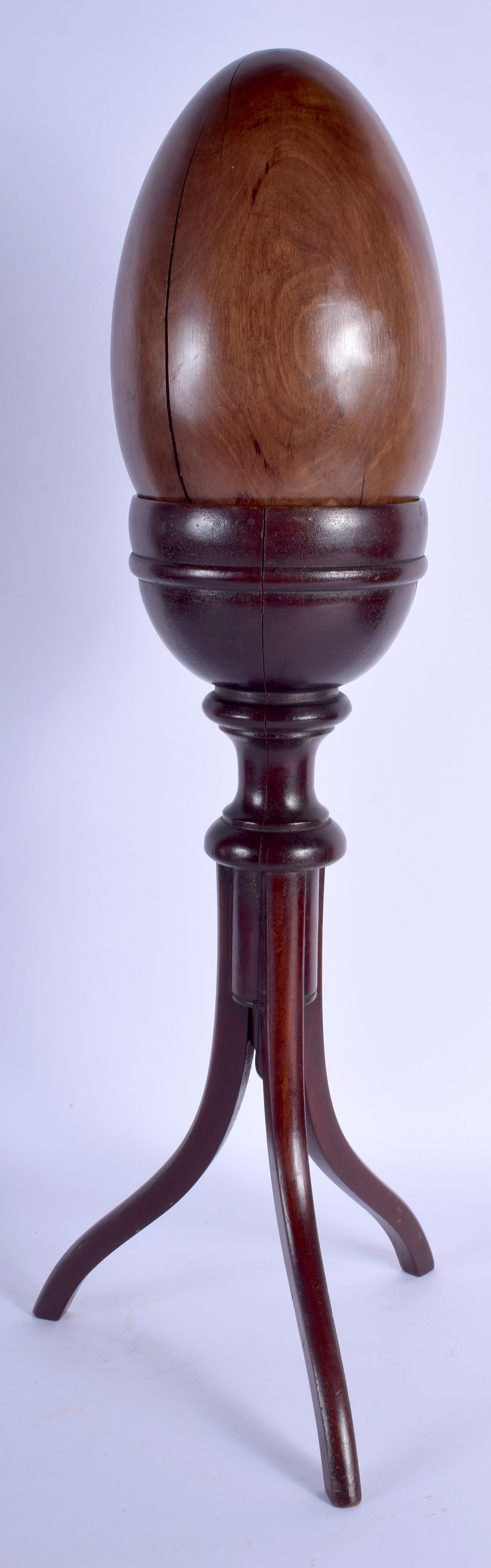 A LARGE ANTIQUE LIGNUM VITAE SPECIMAN EGG upon a stand. 55 cm high.