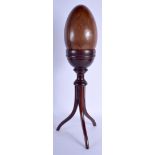 A LARGE ANTIQUE LIGNUM VITAE SPECIMAN EGG upon a stand. 55 cm high.