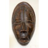A TRIBAL DAN MASK. Ivory Coast. 14cm x 8cm x 27cm