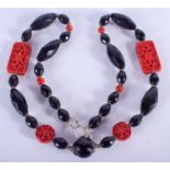 A 1930S CHINESE PEKING GLASS AND CINNABAR LACQUER NECKLACE. 65 cm long.