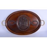 A RARE MID 19TH CENTURY CARVED WOOD AND BRASS RIM TRAY set within a central armorial plaque. 64 cm