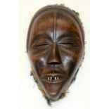 A TRIBAL DAN MASK. Ivory Coast. 15cm x 7cm x 26cm