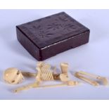 A RARE ANTIQUE CAVRED IVORY MEMENTO MORI SKELETON within a Japanese lacquered box. (qty)